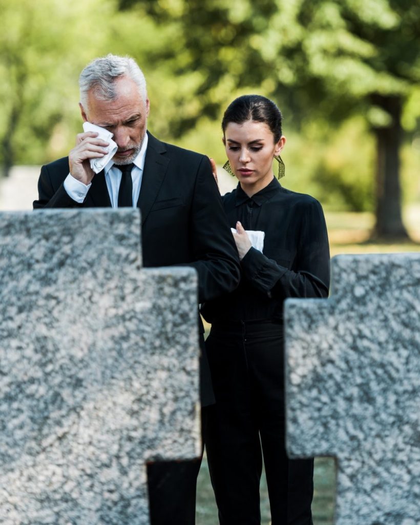 selective-focus-of-upset-man-crying-near-woman-on-funeral-e1636904714900.jpg